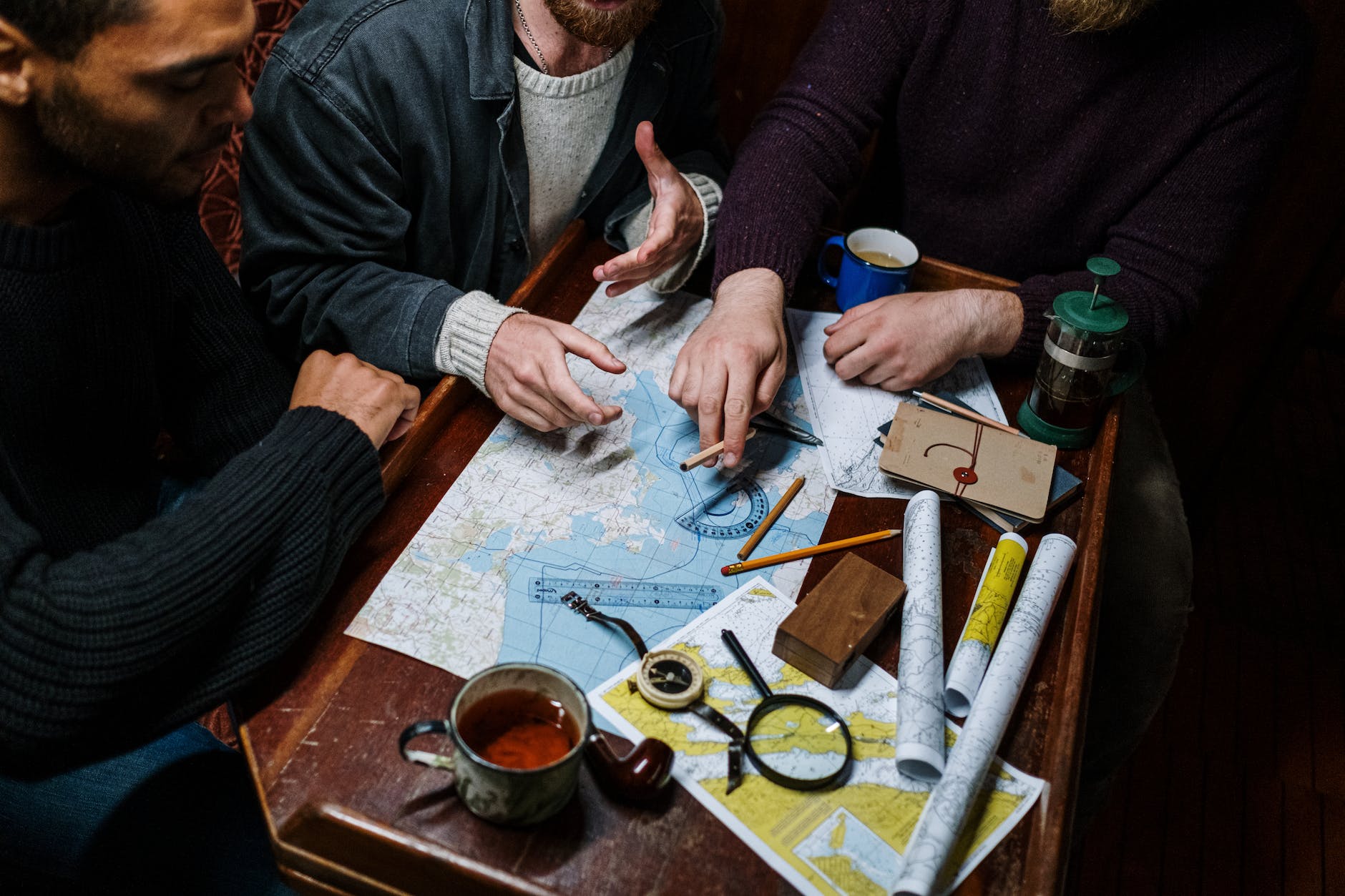 men planning a route using map